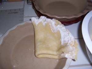 Using your pastry mat to help fold the crust, fold into quarters and move to your pie plate.